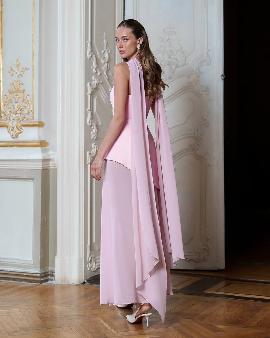 Woman wearing a pink dress with a long train in an elegant interior setting