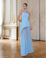 Woman wearing a light blue dress in an elegant interior setting