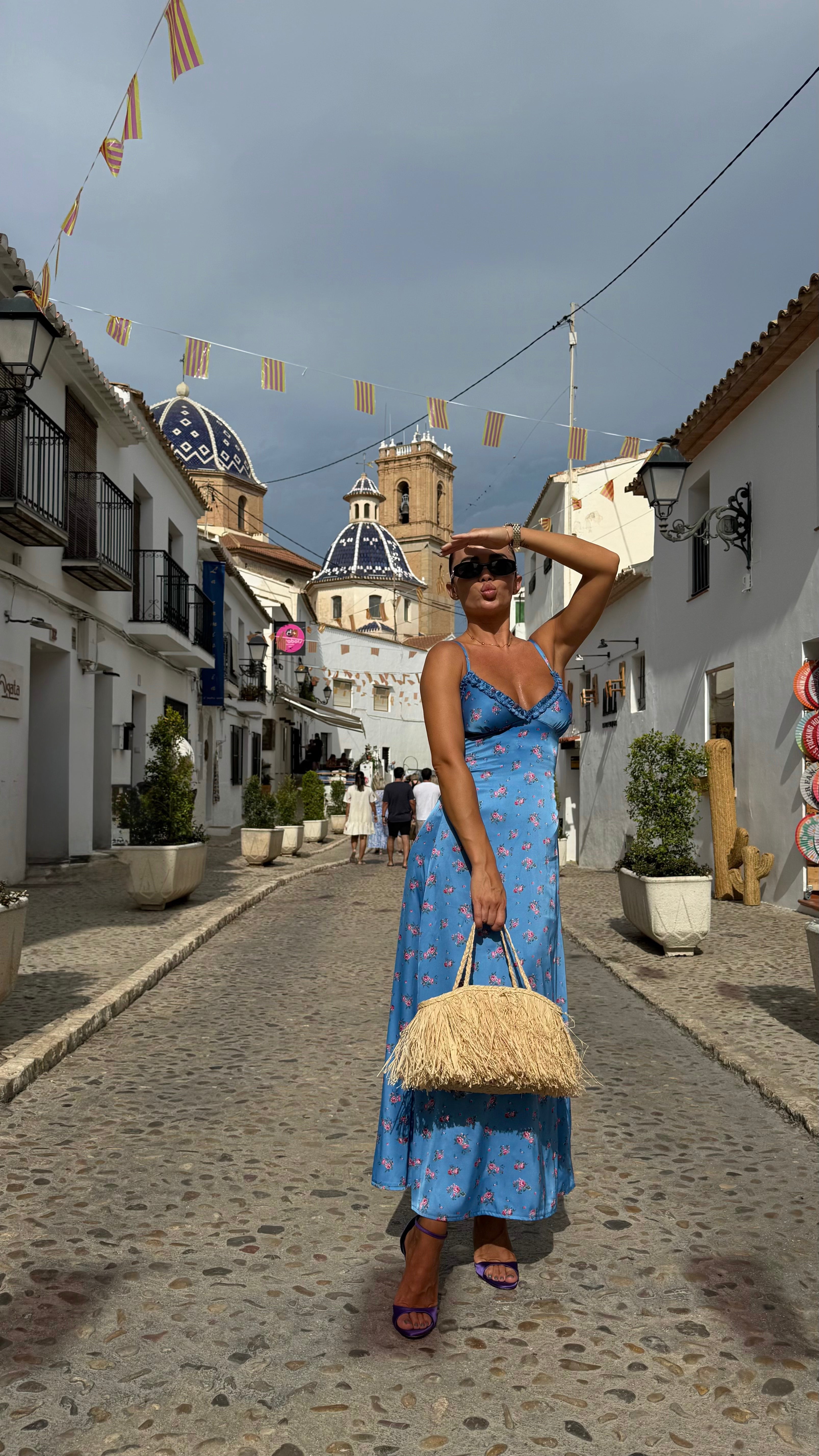 Beautiful girl in Blue Floral Midi Dress with Straps on the street 