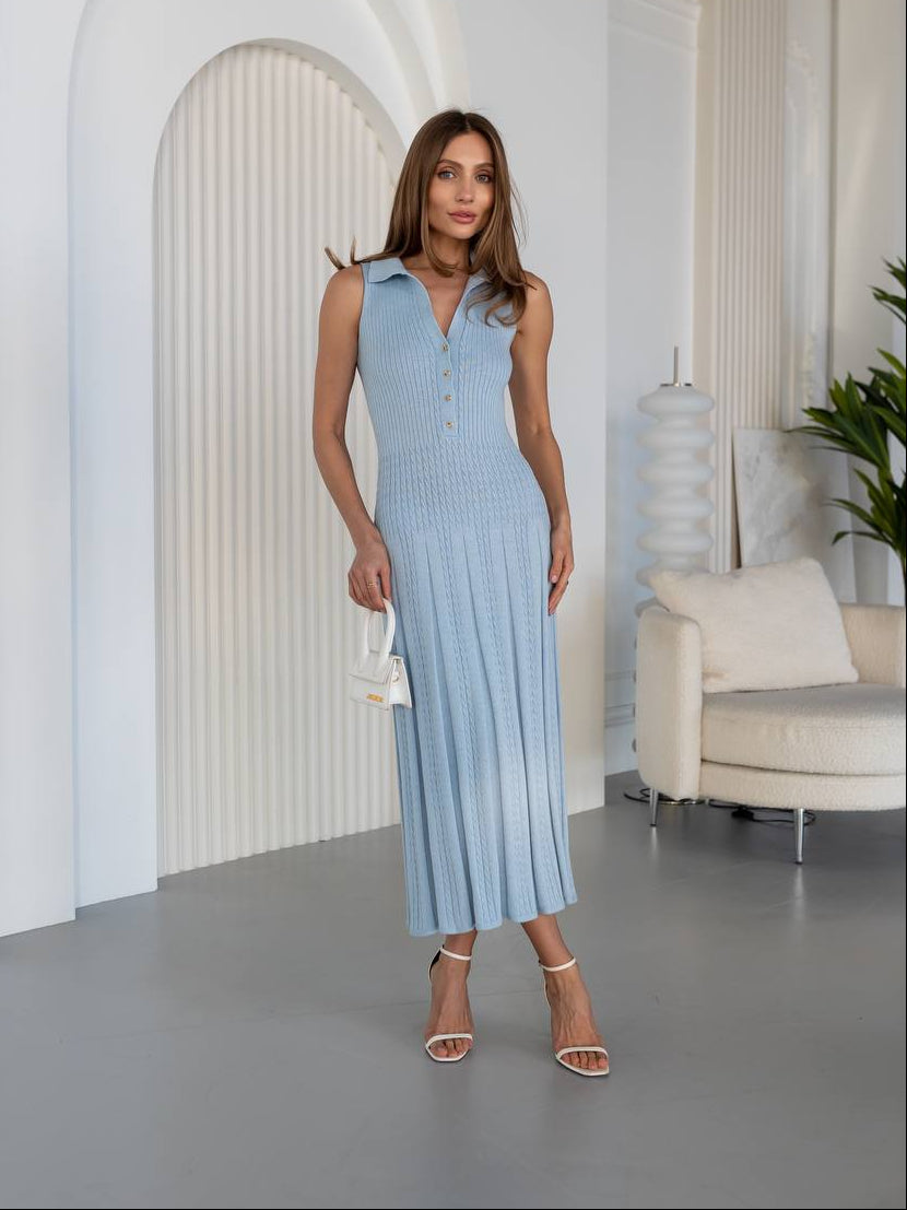 Woman in a light blue dress standing in a modern interior setting