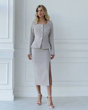 Woman wearing a gray suit with a white background