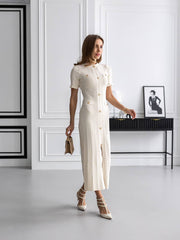 Woman in a white dress standing in a modern interior setting
