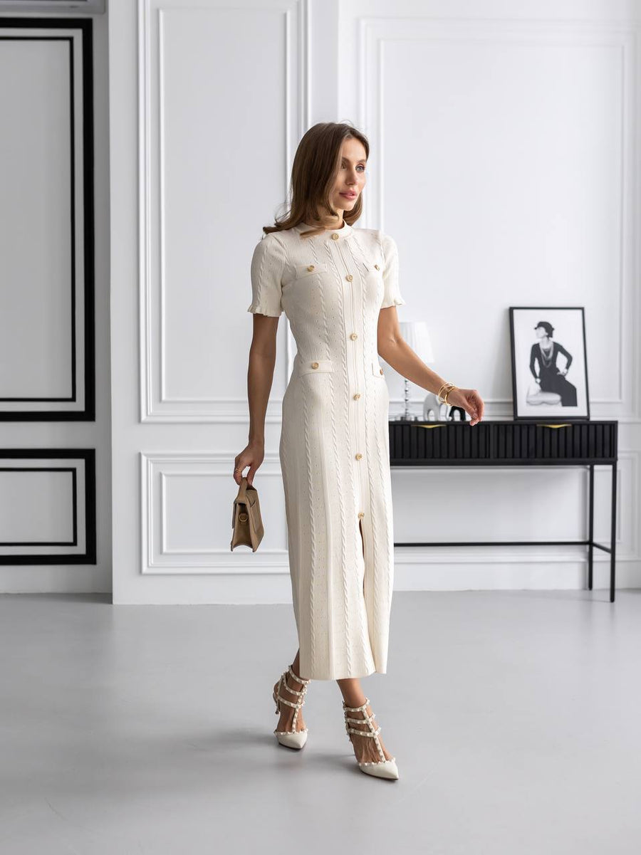 Woman in a white dress standing in a modern interior setting