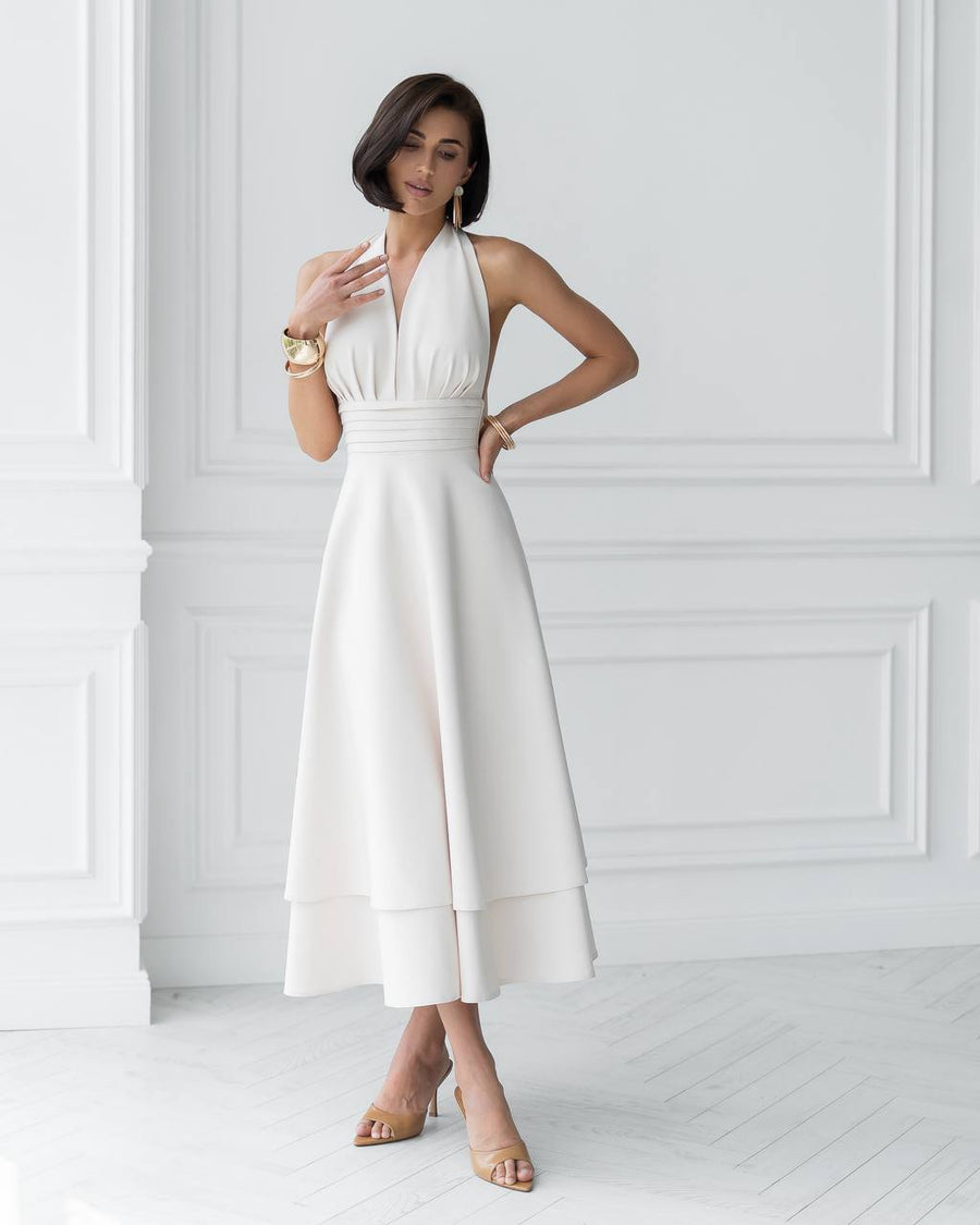 Woman wearing a white dress in a minimalistic setting